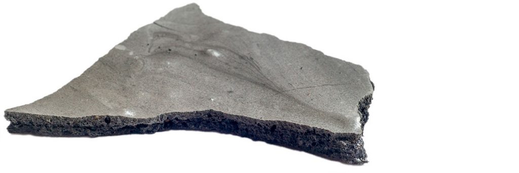 Nahaufnahme von einem Stück Lakritzbaiser-Platte, einer Komponente von Bergamotteneis mit Lakritzbaiser